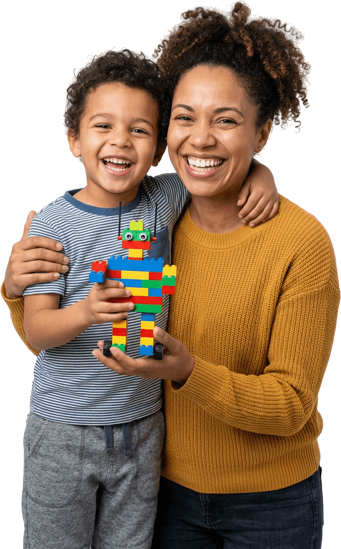 A parent and child smiling with a toy robot they built