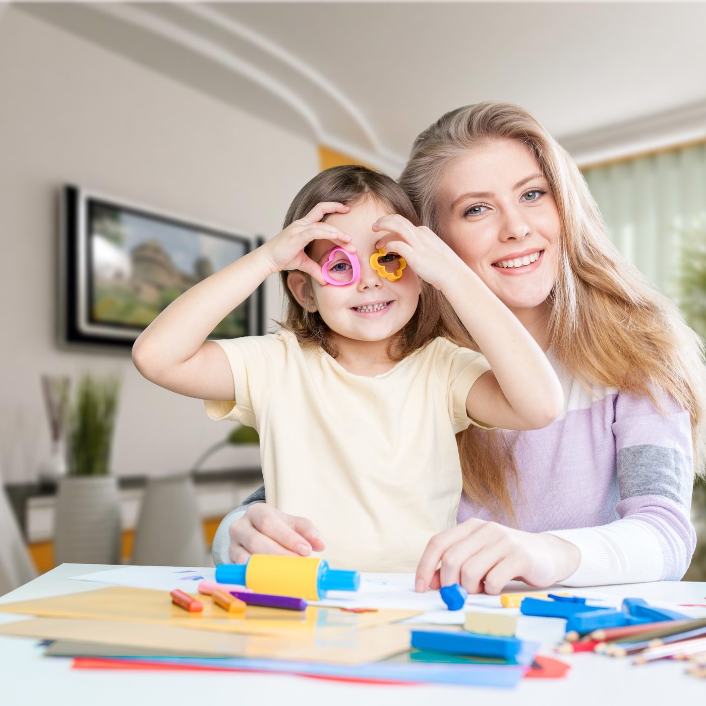 A parent and child doing a craft activity together