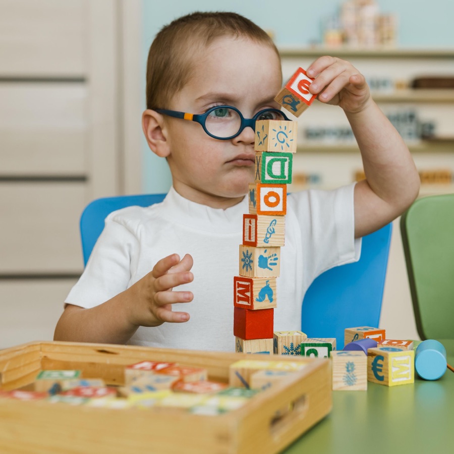 A child stacking alphabet blocks during an assessment