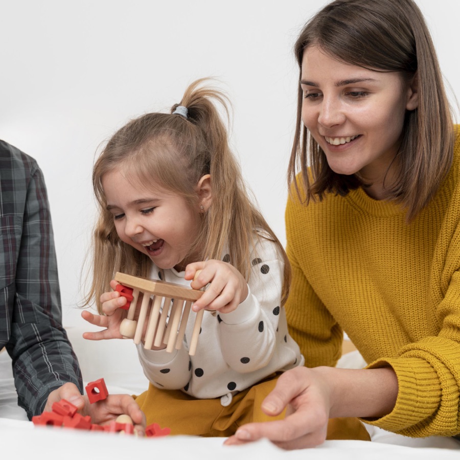 A parent and child laughing together while playing